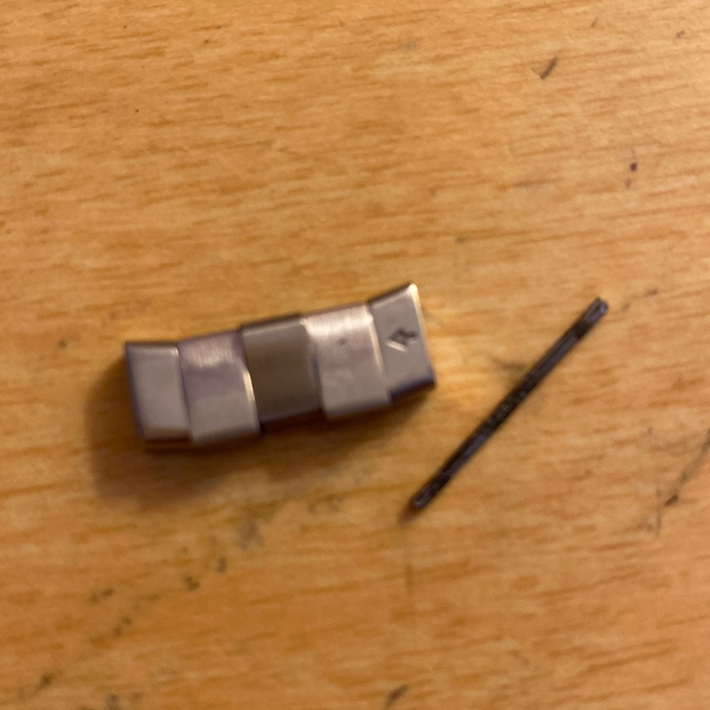 A watch link and a pin for it
